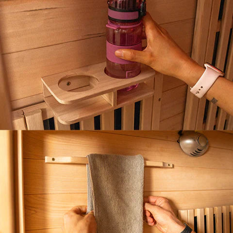 Person using a wooden sauna shelf to hold a pink bottle and a gray towel.
