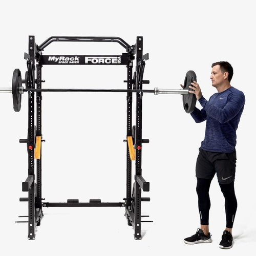 Load image into Gallery viewer, Force USA MYRack Space Saver Folding Power Cage front view with man and several attachments
