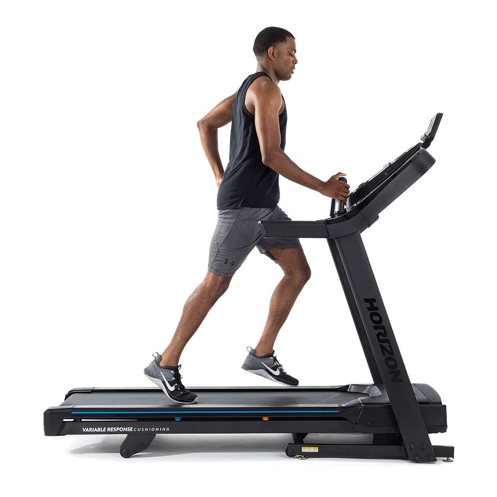 Horizon 7.0AT Treadmill side view in use by man