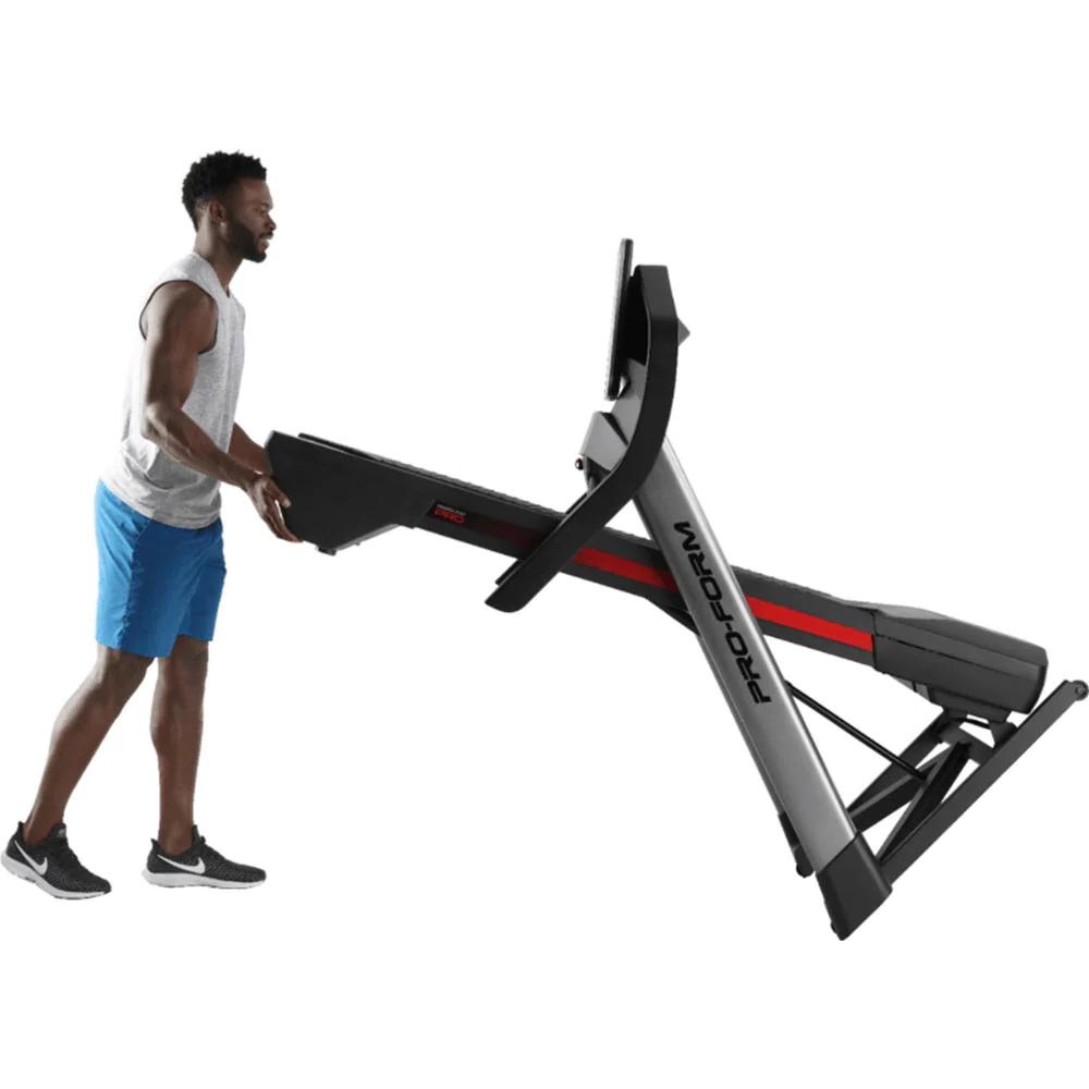 Proform Pro 2000 Treadmill side view folded while being pushed by man