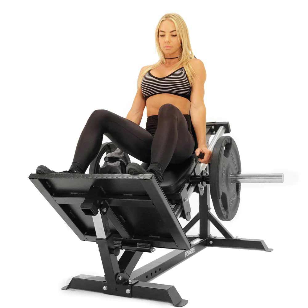Force USA Compact Leg Press/Calf Raise front view with woman